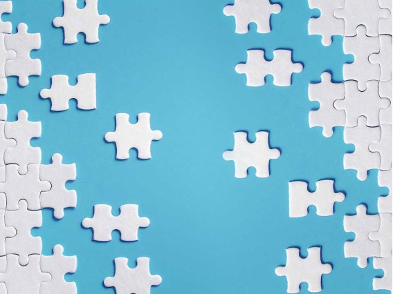 An all white puzzle sits on a light blue background.