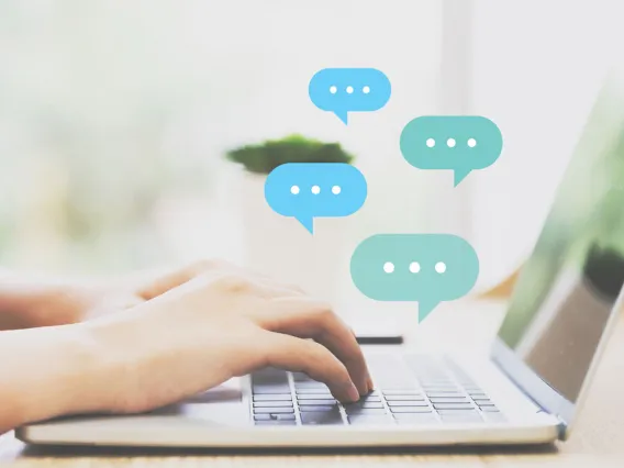 Close-up of someone having a chat conversation on her laptop.