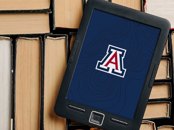 A reading tablet with the UArizona logo on the screen sits on top of a bunch of books.