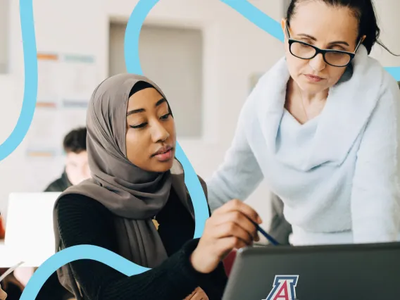 A UArizona instructor helps a student with an online assignment.