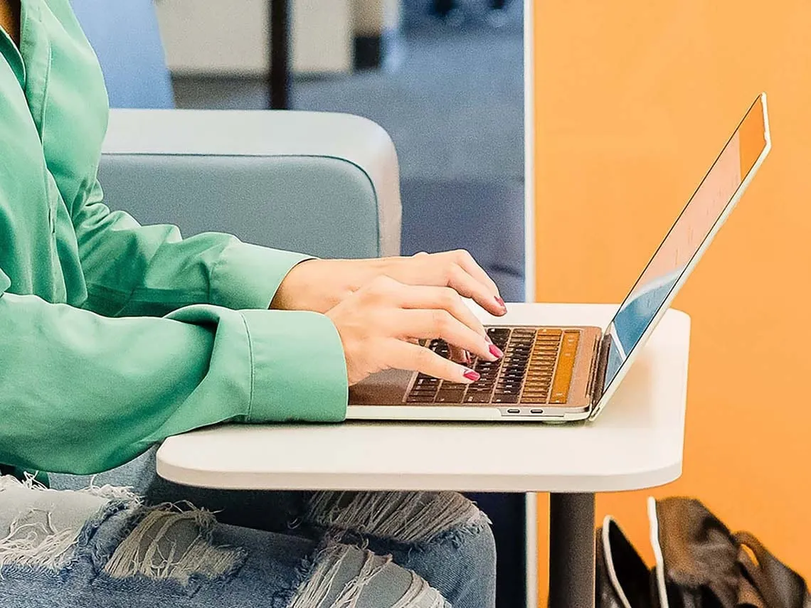 A student is taking a course survey on her laptop computer.