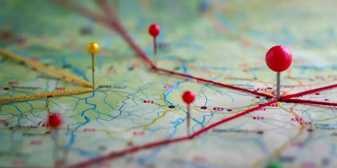 A close-up of a paper map with some push pins marking some relevant spots.