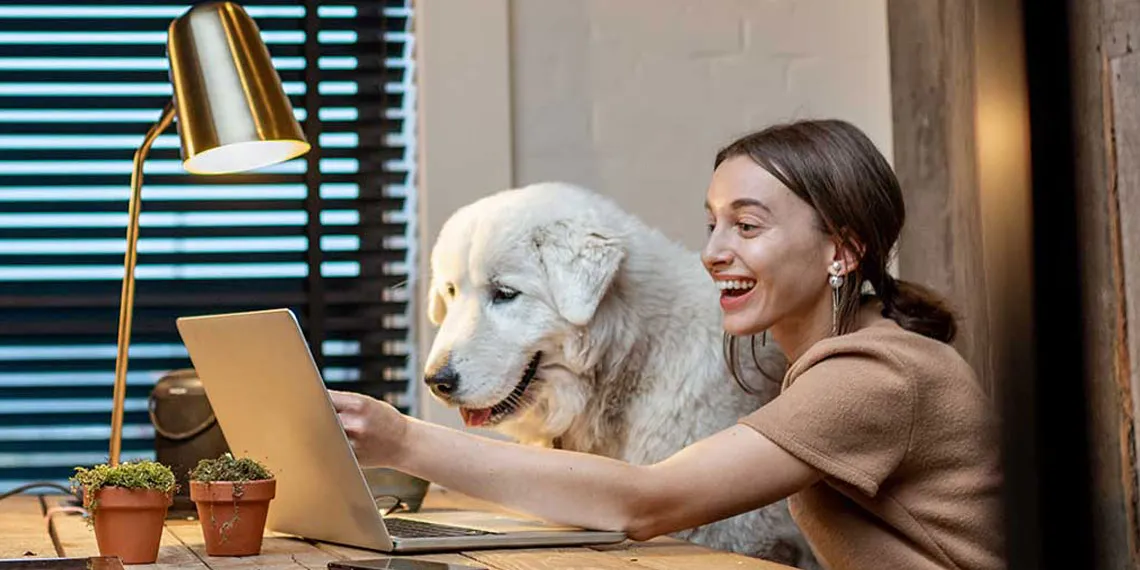 A student and her dog are interacting with classmates while using new technology in their online course.
