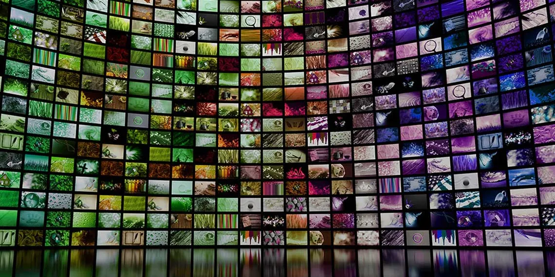 A wall of hundreds of digital screens displaying different images.