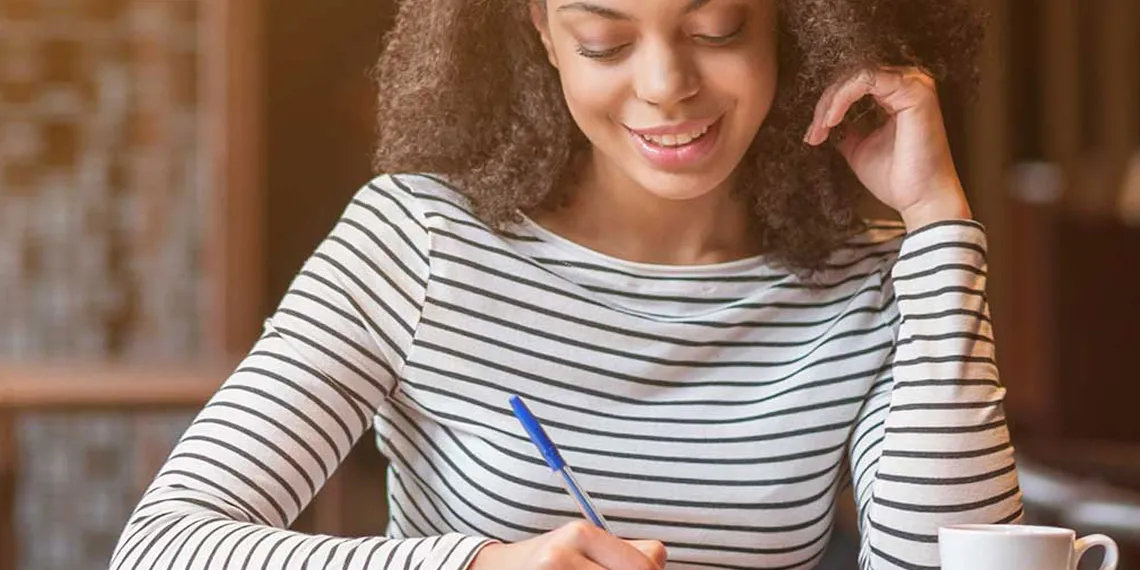 An instructor is writing measurable learning outcomes in her notepad.