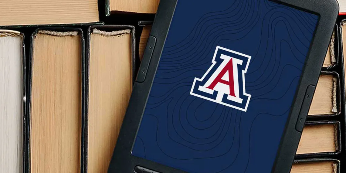 A reading tablet with the UArizona logo on the screen sits on top of a bunch of books.