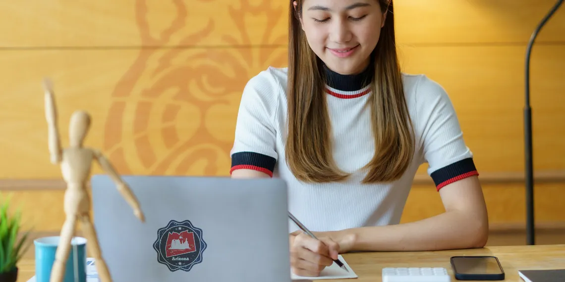 A female UArizona student is engaged in her online course.